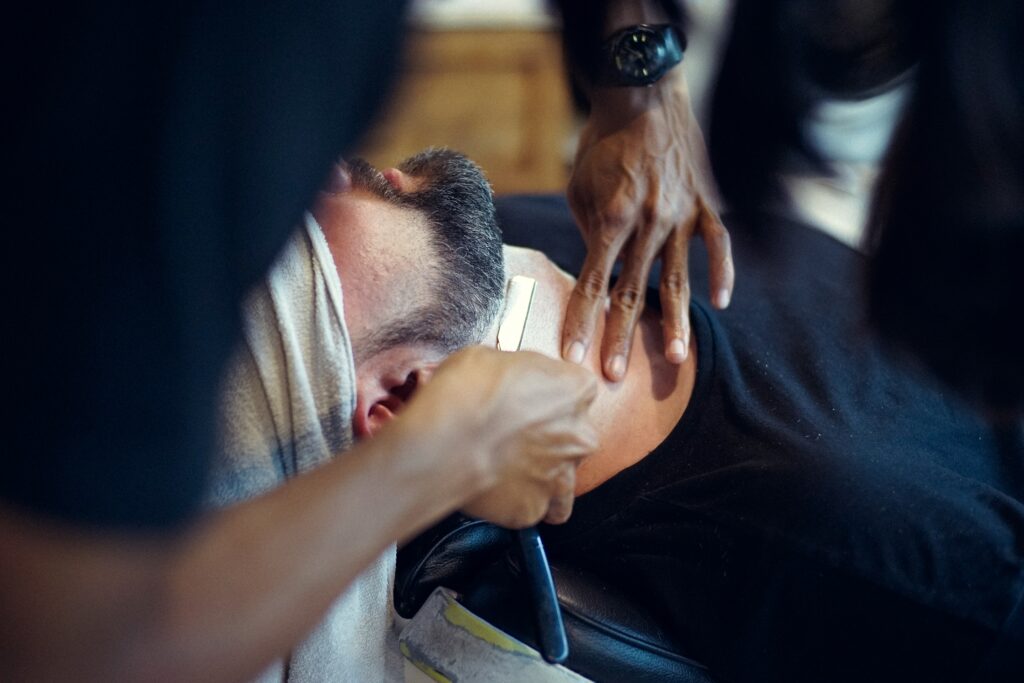 a man shaving at the barbershop