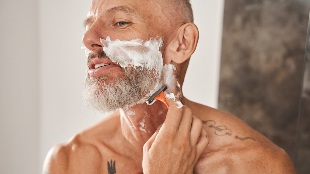 older man shaving
