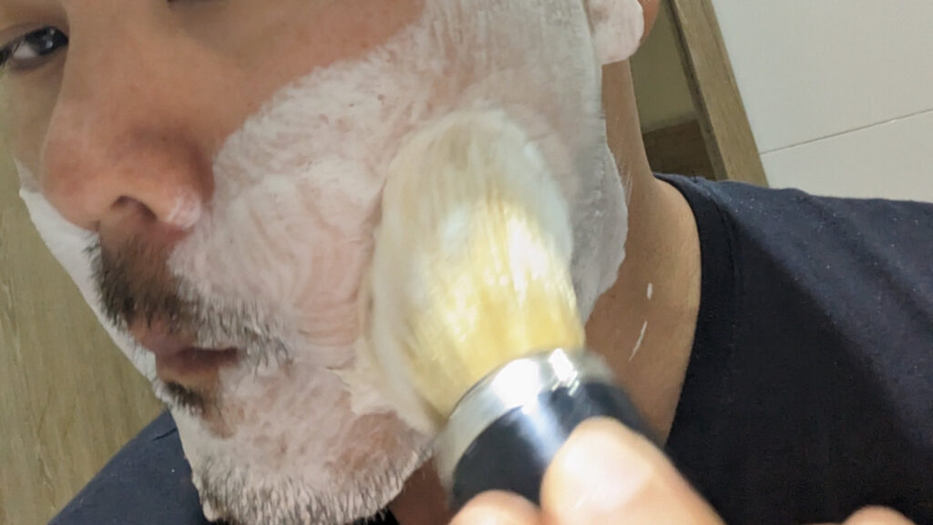 putting shaving soap on face